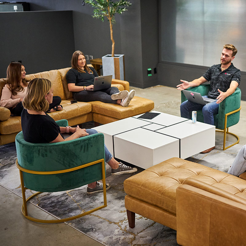 Openloop employees sitting in a seating area